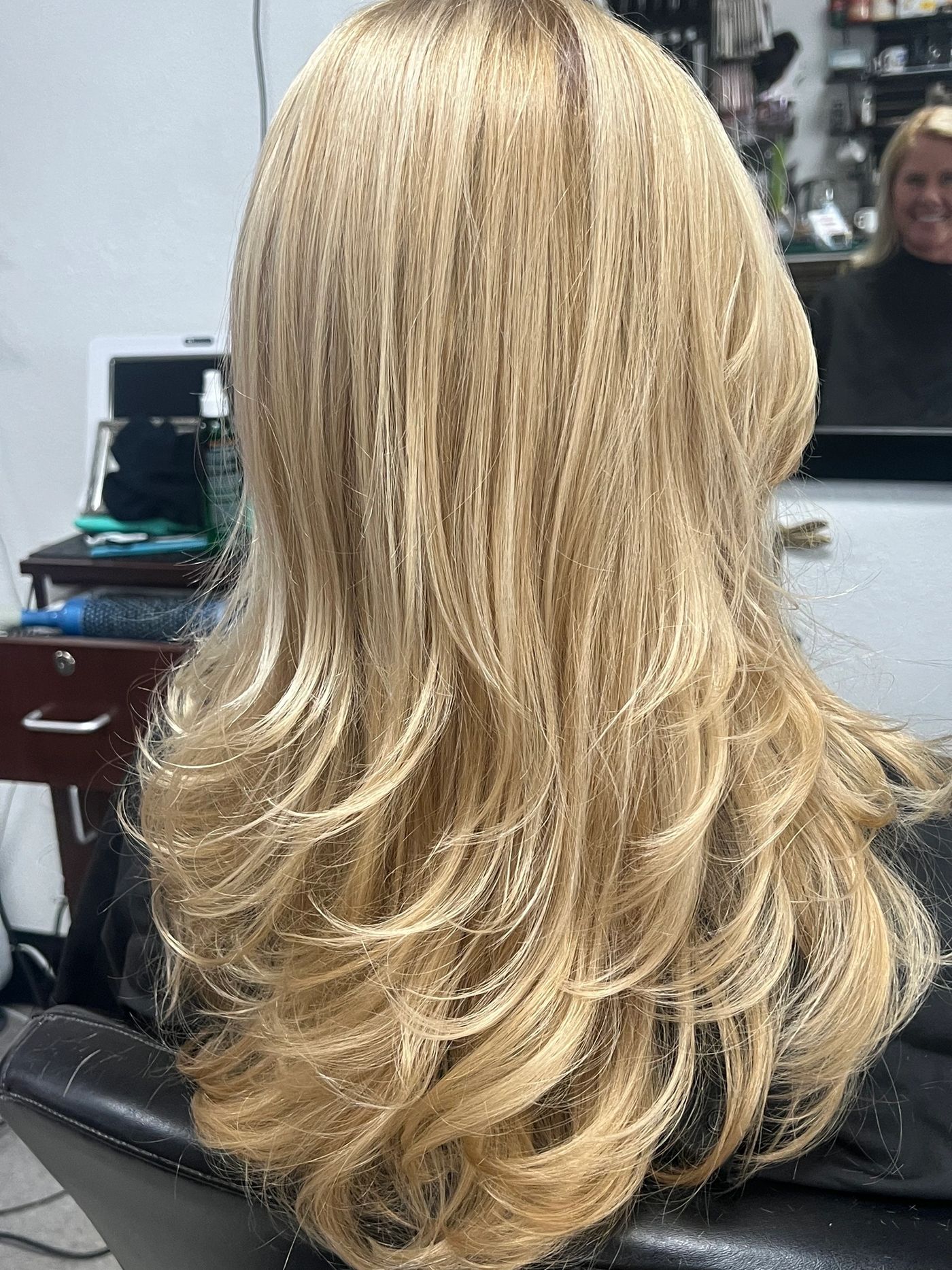 Long blonde hair with soft layers styled in the salon